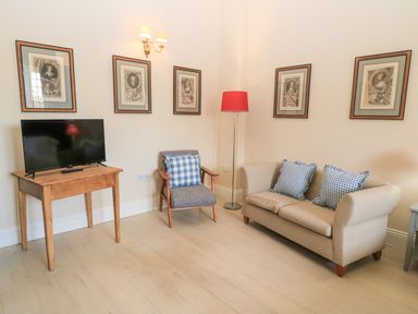 A living room with a television and seating area at Woodcock Studio Andoversford near Cheltenham