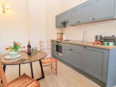 A kitchen with a table set for a meal at Swallow Studio Andoversford near Cheltenham