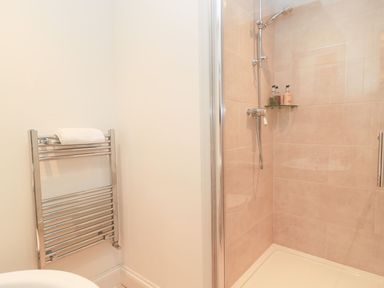 A bathroom with a shower and towel rail at Swallow Studio Andoversford near Cheltenham