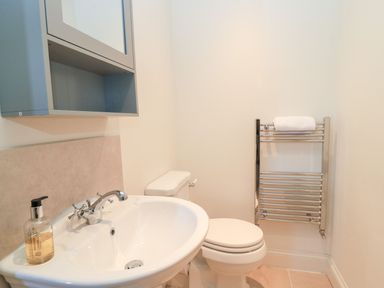 A bathroom with a sink and toilet at Swallow Studio in Andoversford near Cheltenham