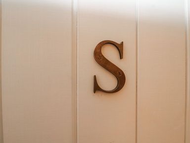 A decorative letter 'S' mounted on a wall at Swallow Studio Andoversford near Cheltenham