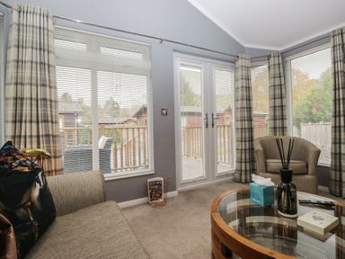 A snug with a sofa and coffee table at 32 Grasmere, White Cross Bay near Windermere