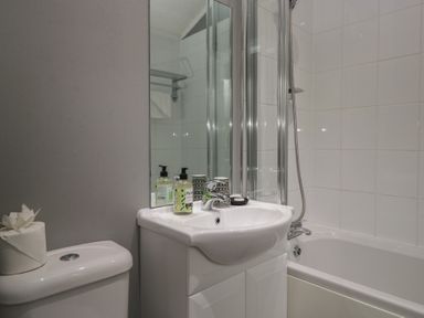 A bathroom with a sink and bathtub at 32 Grasmere, White Cross Bay near Windermere