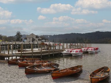 A dock with boats and a building at 7 Lake View, Windermere