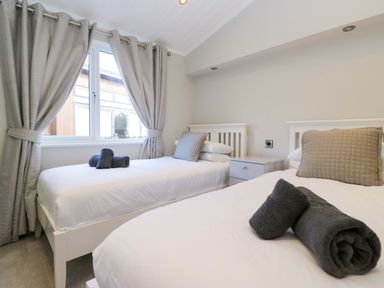 A bedroom with two beds and window at 7 Lake View, Lake View 7, White Cross Bay near Windermere