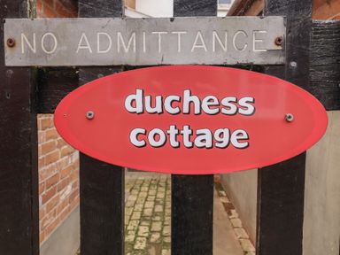 Sign indicating duchess cottage at outdoor entrance