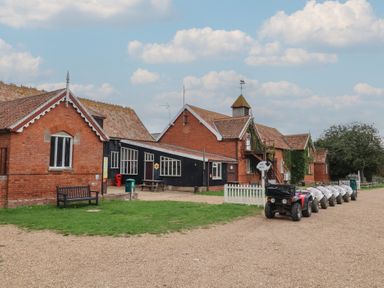 An outdoor area with buildings and a quad bike at Duchess Cottage in Woodbridge