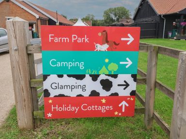 A directional sign for farm park, camping, glamping, and holiday cottages at Duchess Cottage in Woodbridge