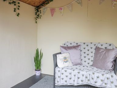 A snug with a sofa and plant in Rushmoor Cottage Colaton Raleigh