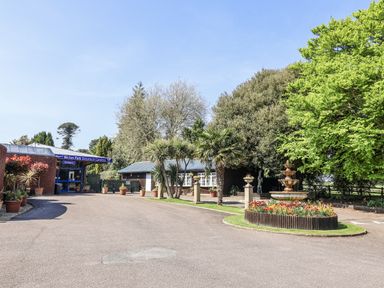 An entrance area with a fountain and potted plants at Bicton Park Botanical Gardens