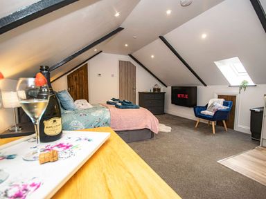 A bedroom with a bed and television at Thomas Chambers in Camborne