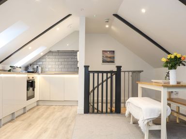 A kitchen area with a stove and sink at Thomas Chambers in Camborne