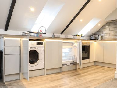 A kitchen with appliances and cabinets at Thomas Chambers in Camborne