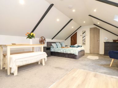 A bedroom with a bed and table at Thomas Chambers in Camborne