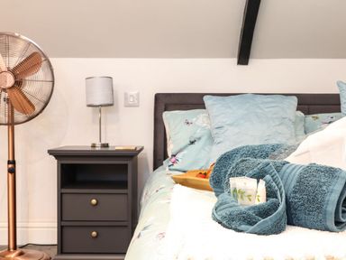 A bedroom with a bed and bedside table at Thomas Chambers in Camborne