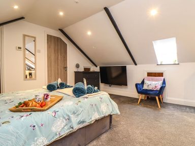 A bedroom with a bed and television at Thomas Chambers in Camborne
