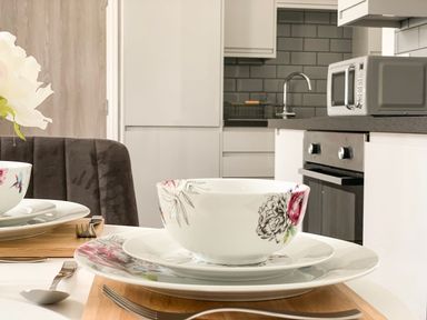 A dining setup with dishes on a table in Baker Chambers Camborne