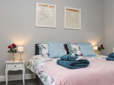 A bedroom with a bed and decorative pillows at Baker Chambers in Camborne
