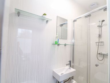 A bathroom with a shower and sink at Teylu in Camborne