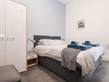 A bedroom with a bed and nightstand at Teylu in Camborne