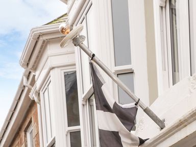 A flag on a pole attached to a building at Battell Chambers in Camborne