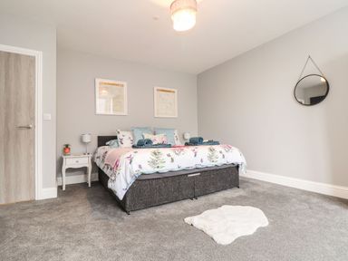 A bedroom with a bed and nightstand at Battell Chambers in Camborne