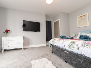 A bedroom with a bed and television at Battell Chambers in Camborne