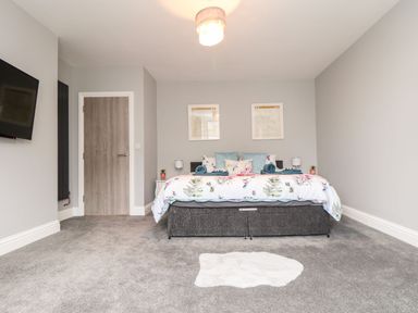 A bedroom with a bed and television at Battell Chambers in Camborne