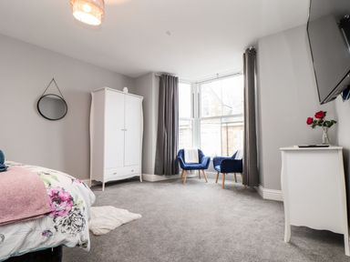 A bedroom with a bed and wardrobe at Battell Chambers in Camborne
