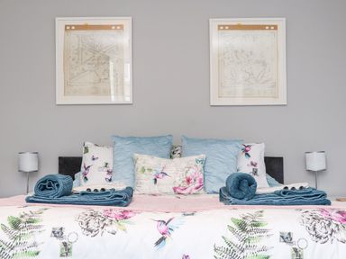 A bedroom with a bed and decorative pillows at Battell Chambers Camborne