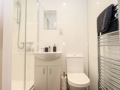 A bathroom with a shower, sink, and toilet at Battell Chambers, Camborne