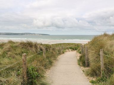 A pathway leading to the ocean at Battell Chambers in Camborne