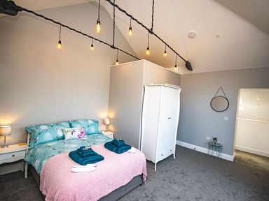 A bedroom with a bed and wardrobe at Daniel Chambers in Camborne