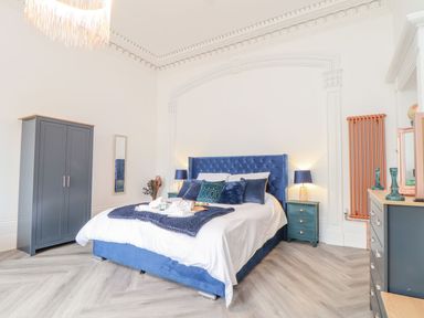 A bedroom with a bed and wardrobe at Mews Retreat in Camborne
