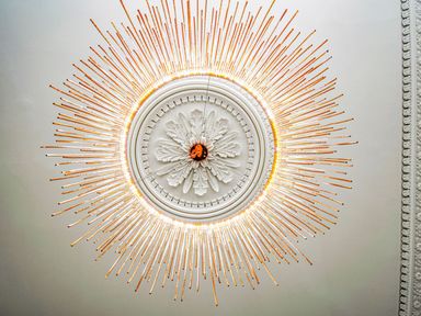 A chandelier with decorative ceiling medallion at Mews Retreat in Camborne