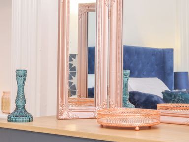 A bedroom with a mirror and decorative items at Mews Retreat in Camborne