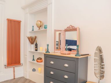 A living room with a dresser and decorative items at Mews Retreat Camborne