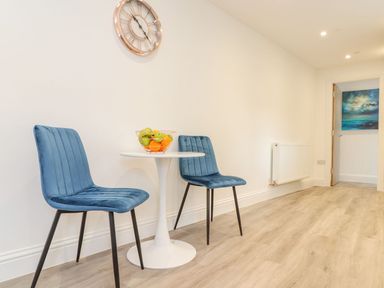 A dining area with chairs and a table at Mews Retreat in Camborne