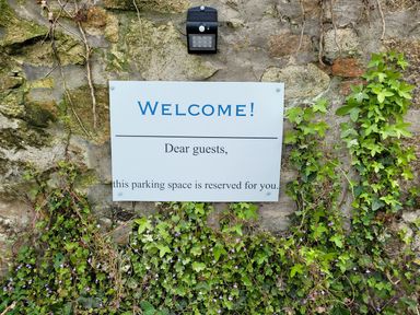 A welcome sign indicating a reserved parking space at Mews Retreat in Camborne