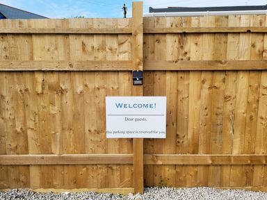 A parking sign on a wooden fence in an outdoor area at Mews Retreat Camborne