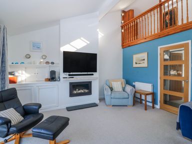 A living room with a tv and seating area at Gilfach Goed Abersoch