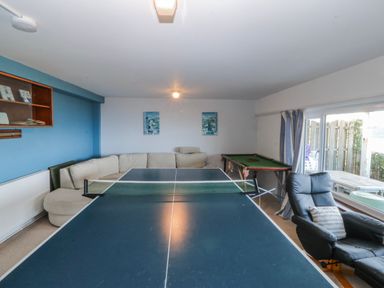 A game room with a table tennis table and a pool table at Gilfach Goed in Abersoch