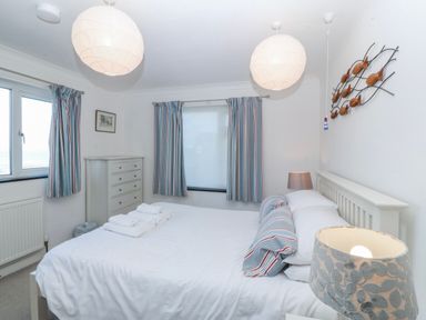 A bedroom with a bed and window at Gilfach Goed in Abersoch