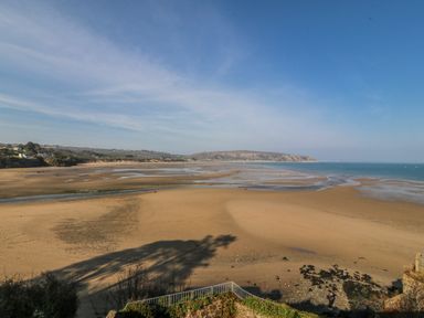 A beach with sand and water at Gilfach Goed in Abersoch