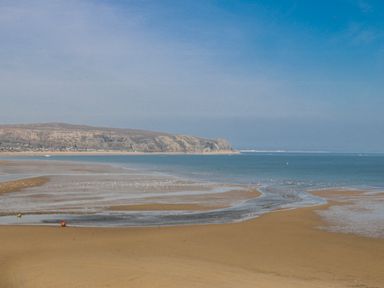 A beach scene with sand and sea at Gilfach Goed in Abersoch