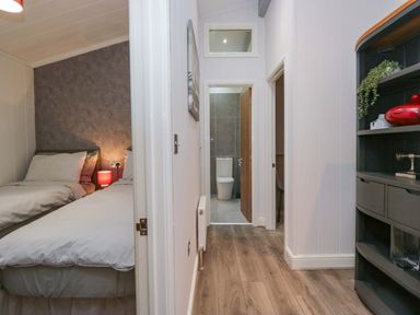 A bedroom with twin beds and a view of the hallway at 5 Waterside Wood Troutbeck Bridge