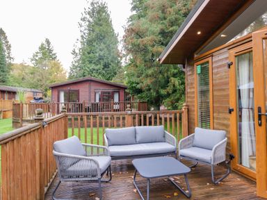 A seating area with a table and chairs at 5 Waterside Wood Troutbeck Bridge