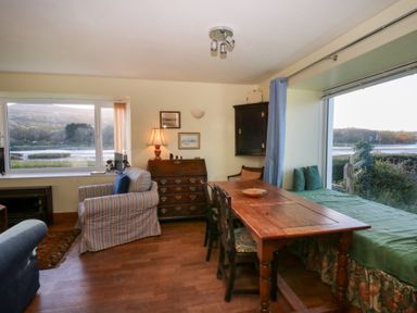 A living room with a table and chairs at Bryncyn in Newport, Pembrokeshire