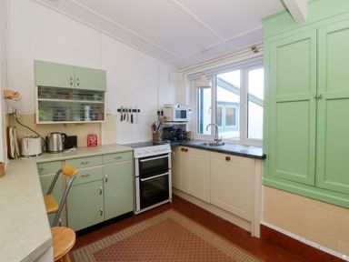 A kitchen with appliances and storage at Bryncyn in Newport, Pembrokeshire