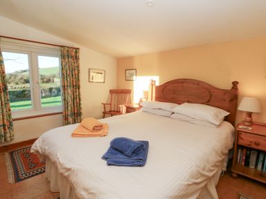 A bedroom with a bed and window at Bryncyn in Newport, Pembrokeshire